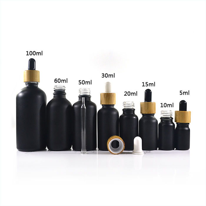 Hot sale 5ml 10ml 15ml 20ml 30ml 50ml 100ml matte frosted black essential oil glass bottle with bamboo dropper cap